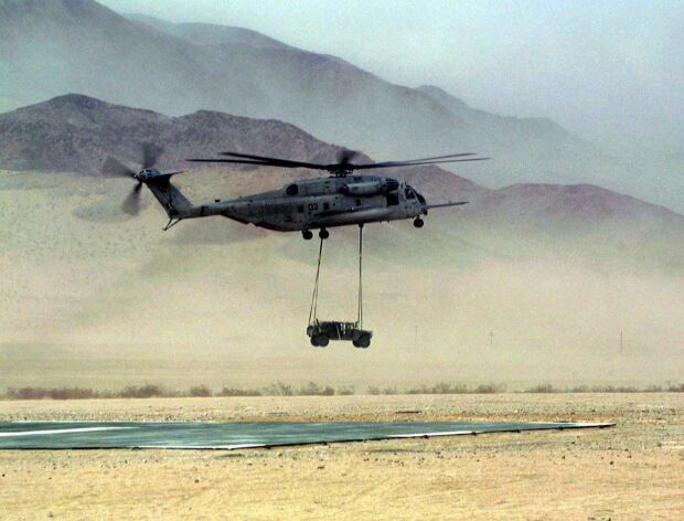 Image: A CH-53E Super Stallion lowers a Humvee to the landing pad at Twentynine Palms.