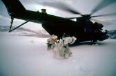Image: Navy Seals egress from a MH-53J Pave Low helicopter