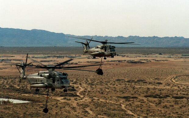 Image: U.S. Marine Corps CH-53E Super Stallions carry a sling load of ammunition.