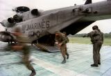 Image: Polish soldiers run out of a CH-53E Super Stallion helicopter at Landing Zone Bluebird.