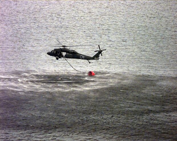 Image: An Army National Guard Blackhawk fills a 700 gallon water bucket to fight forest fires in Florida.