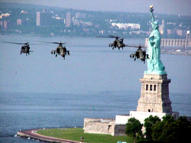 Image: Apache helicopters fly past the Statue of Liberty