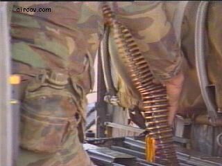 Image: Armorer lays down a belt of 7.62mm ammo for the M134